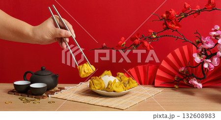 Enjoying dumplings during Chinese New Year celebration Enjoying dumplings during Chinese New Year celebration 132608983
