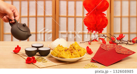 Serving tea and dumplings for Chinese New Year feast Serving tea and dumplings for Chinese New Year feast 132608985