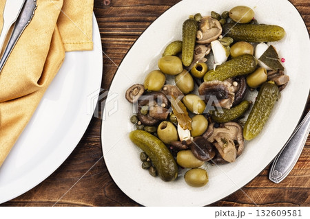 Plate with salty snacks on rustic wooden table. Plate with salty snacks on rustic wooden table. 132609581