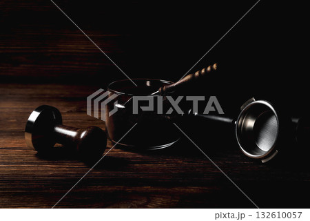 temper portofilter wooden coffee spoon on natural wooden brown background close-up copy space temper portofilter wooden coffee spoon on natural wooden brown background close-up copy space 132610057
