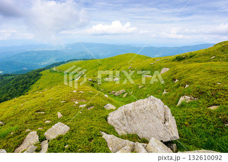 breathtaking mountain landscape with massive rocks on alpine meadow in summer. beautiful nature of carpathian alps. dramatic scenery with hills and green slopes under overcast sky. outdoor adventure 132610092