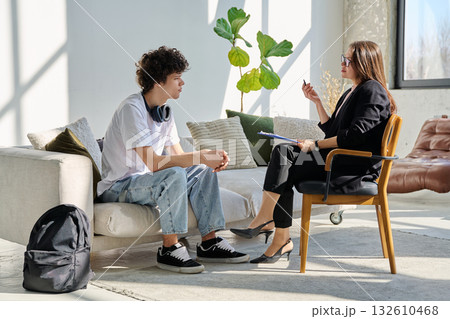 Young man in mental session talking with professional psychologist Young man in mental session talking with professional psychologist 132610468