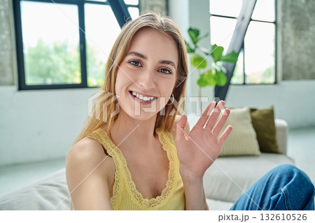 Close-up selfie portrait of teenage female looking waving hand at web camera Close-up selfie portrait of teenage female looking waving hand at web camera 132610526