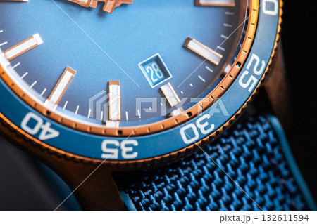 Date window and bronze blue bezel of a mens wristwatch with blue dial Date window and bronze blue bezel of a mens wristwatch with blue dial 132611594