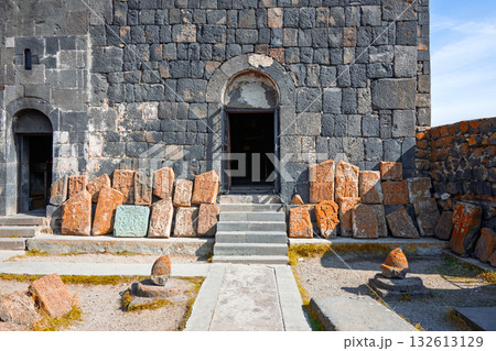 A stone building with a large archway and a pile of rocks in front of it A stone building with a large archway and a pile of rocks in front of it 132613129