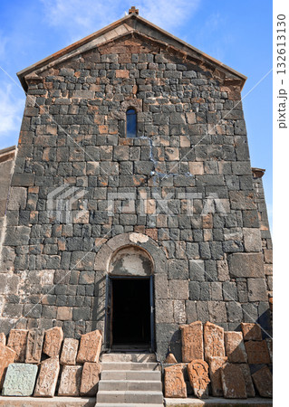 A large stone building with a small doorway A large stone building with a small doorway 132613130