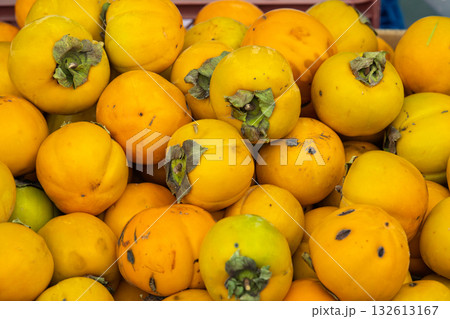 A pile of oranges with green stems A pile of oranges with green stems 132613167