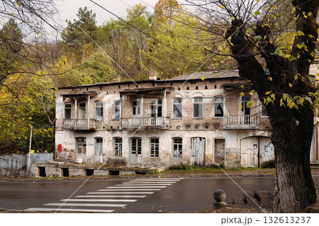 A run down building with a tree in front of it A run down building with a tree in front of it 132613237