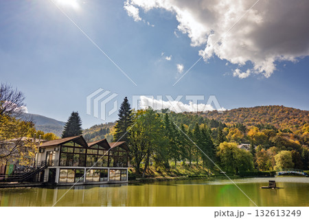 A lake with a house on the shore 132613249
