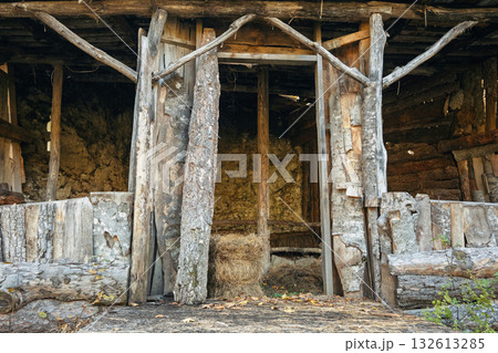 A small, old building with a wooden door 132613285