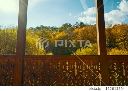 A wooden fence with a view of a forest 132613294