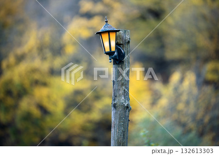 A lamp post with a light on top of it A lamp post with a light on top of it 132613303