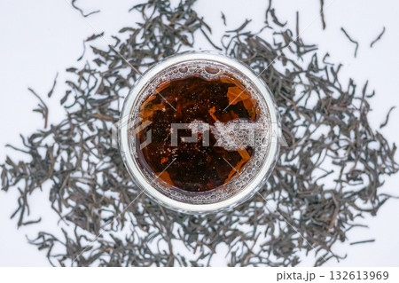 Top View of Freshly Brewed Black Tea with Loose Leaves on White Background 132613969