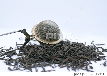 Loose Leaf Black Tea with Metal Tea Infuser on White Background Loose Leaf Black Tea with Metal Tea Infuser on White Background 132613981