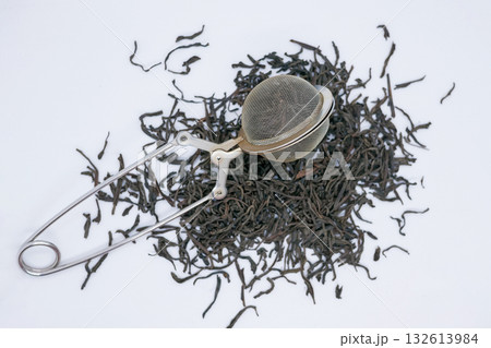 Loose Leaf Black Tea with Metal Tea Infuser on White Background Loose Leaf Black Tea with Metal Tea Infuser on White Background 132613984