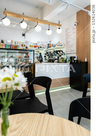 Cozy cafe interior with counter and bright lighting during the day Cozy cafe interior with counter and bright lighting during the day 132614036