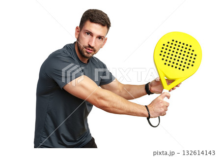 Man swinging a bright yellow paddle with determination during an energetic game session 132614143
