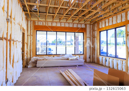 Inside building under construction exposed framing, insulation, unfinished floors, tools, materials. Inside building under construction exposed framing, insulation, unfinished floors, tools, materials. 132615063