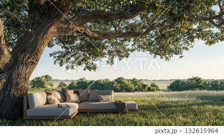 Cozy couch placed under big tree in sunny garden, relaxing outdoor living concept 132615964