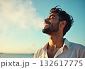 An attractive man breathes fresh air from nature at sunset. Healthy lifestyle and emotional well-being 132617775