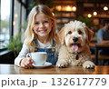 Pretty smiling girl with small dog in her arms sitting at table in restaurant with cup of coffee. Woman with dark hair in cafe with pet on dark background. 132617779