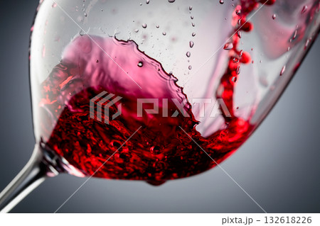 Red wine is poured into a glass. Red wine is poured into a glass. 132618226
