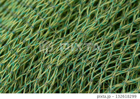 Stacked fishing nets in various colors and textures create a composition of maritime life. 132618299