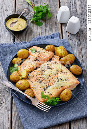 Salmon fillet with cheese, spices, baby potatoes Salmon fillet with cheese, spices, baby potatoes 132618383