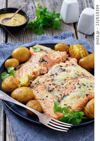Salmon fillet with cheese, spices, baby potatoes Salmon fillet with cheese, spices, baby potatoes 132618384