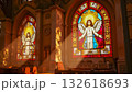 A ray of bright sun passes through the stained glass of the cathedral, as a sign of God, shimmering and shining in the glass, Catholic faith. 132618693