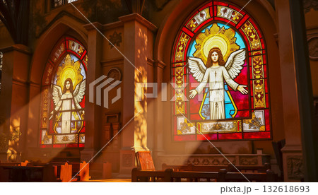 A ray of bright sun passes through the stained glass of the cathedral, as a sign of God, shimmering and shining in the glass, Catholic faith. A ray of bright sun passes through the stained glass of the cathedral, as a sign of God, shimmering and shining in the glass, Catholic faith. 132618693