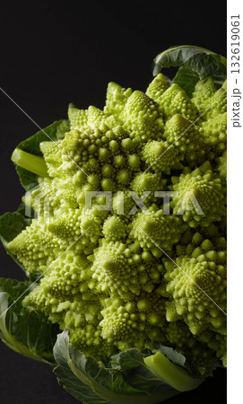 Unique romanesco cauliflower on a dark background showing intricate patterns Unique romanesco cauliflower on a dark background showing intricate patterns 132619061