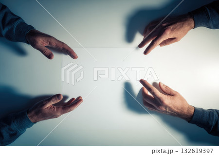 Two hands almost touching above white table with soft shadow adult male creative concept minimal style top view copy space teamwork communication connection calm mood 132619397