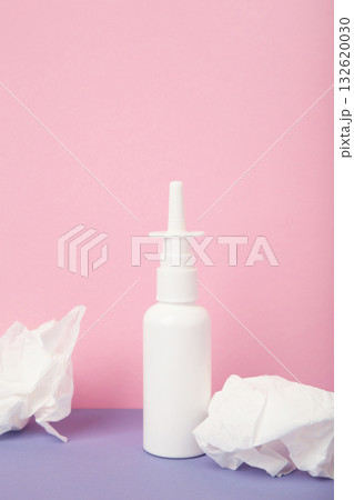 Nasal drops medicine bottle on pink background. Vertical photo 132620030