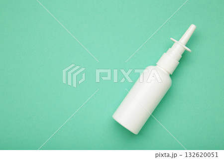 Nasal drops medicine bottle on mint background. Space for text Nasal drops medicine bottle on mint background. Space for text 132620051