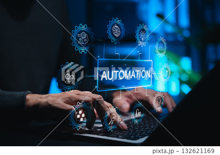 Automation concept in technology and business. Person using laptop while gear icons symbolizing AI, workflow automation, data analysis, cloud computing, and smart industry surround AUTOMATION label. 132621169