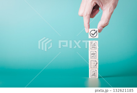Document review process and quality control concept. Hand placing checkmark. wooden blocks document icons, symbolizing document verification, business approval process, certificate management, audit, 132621185