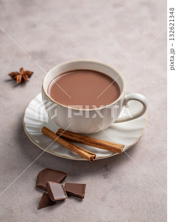 Hot chocolate in a cup on a light background with cinnamon. Concept for a warming homemade drink 132621348