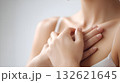 Close up of a young woman performing a breast self exam, promoting early detection and awareness of breast cancer, emphasizing the importance of regular checks for women's health 132621645