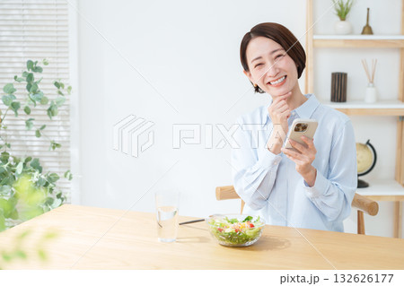 サラダを食べる女性・スマホ サラダを食べる女性・スマホ 132626177
