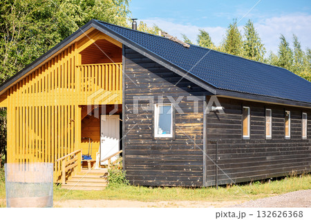 Barnyard on summer day. Modern, eco-friendly barns for cows and sheep, and hay storage sheds. High quality photo Barnyard on summer day. Modern, eco-friendly barns for cows and sheep, and hay storage sheds. High quality photo 132626368