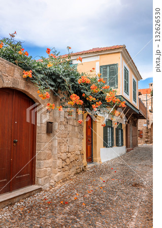 Street view of old town of Rhodes, Greece. Paved roads and pavements with colorful houses and fragrant flowers. High quality photo Street view of old town of Rhodes, Greece. Paved roads and pavements with colorful houses and fragrant flowers. High quality photo 132626530