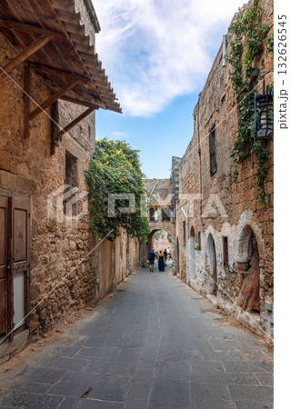 Street view of old town of Rhodes, Greece. Paved roads and pavements with colorful houses and fragrant flowers. High quality photo 132626545