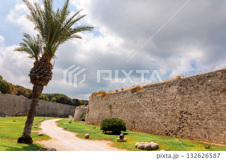 Stone powerful walls of old city, the ancient defense of Old Town, Rhodes, Dodecanese, Greece. High quality photo Stone powerful walls of old city, the ancient defense of Old Town, Rhodes, Dodecanese, Greece. High quality photo 132626587