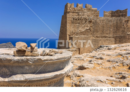 Panoramic view of ruins of ancient city of Lindos on colorful island of Rhodes, Greece. Famous tourist attraction. Ancient temple Greek architecture. High quality photo Panoramic view of ruins of ancient city of Lindos on colorful island of Rhodes, Greece. Famous tourist attraction. Ancient temple Greek architecture. High quality photo 132626616