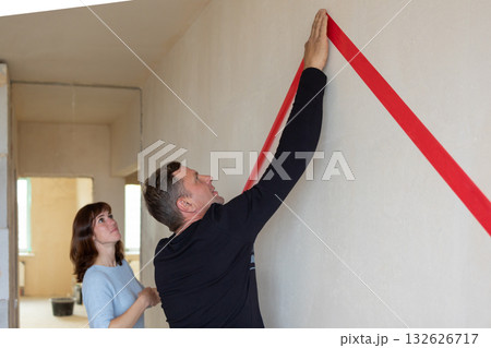 Man hugging his wife. Young couple moving in new apartmen. View from side. Concept new homes, new beginning. High quality photo 132626717