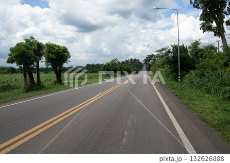 Asphalt road steep path through small hills in rural area. 132626888
