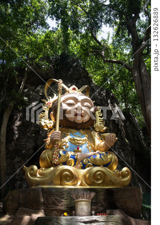 The statue of Sun Wukong in Chibi cartoon style is located between a small mountain gorge. 132626889