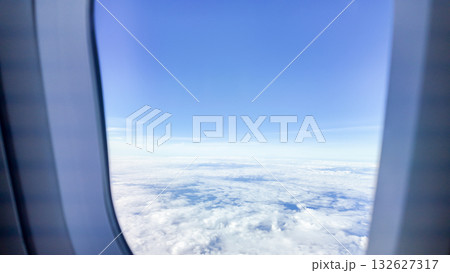 beautiful blue sky with white clouds view from airplane window 132627317