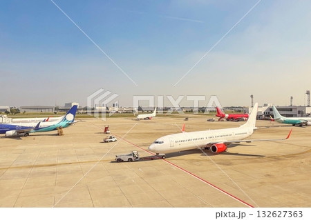 Commercial airplane at the airport with clear blue sky background 132627363